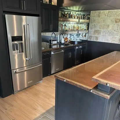 Spotless commercial bar and kitchen with polished stainless appliances and clean copper island